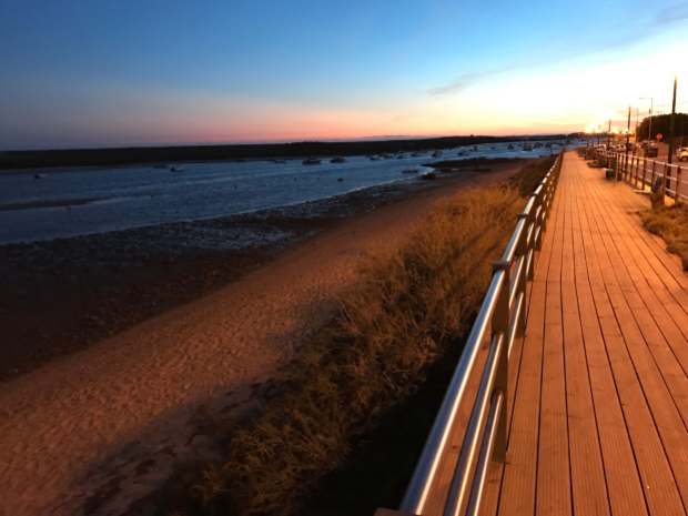 Sunset on the boardwalk in Cabanas, Algarve, Portugal